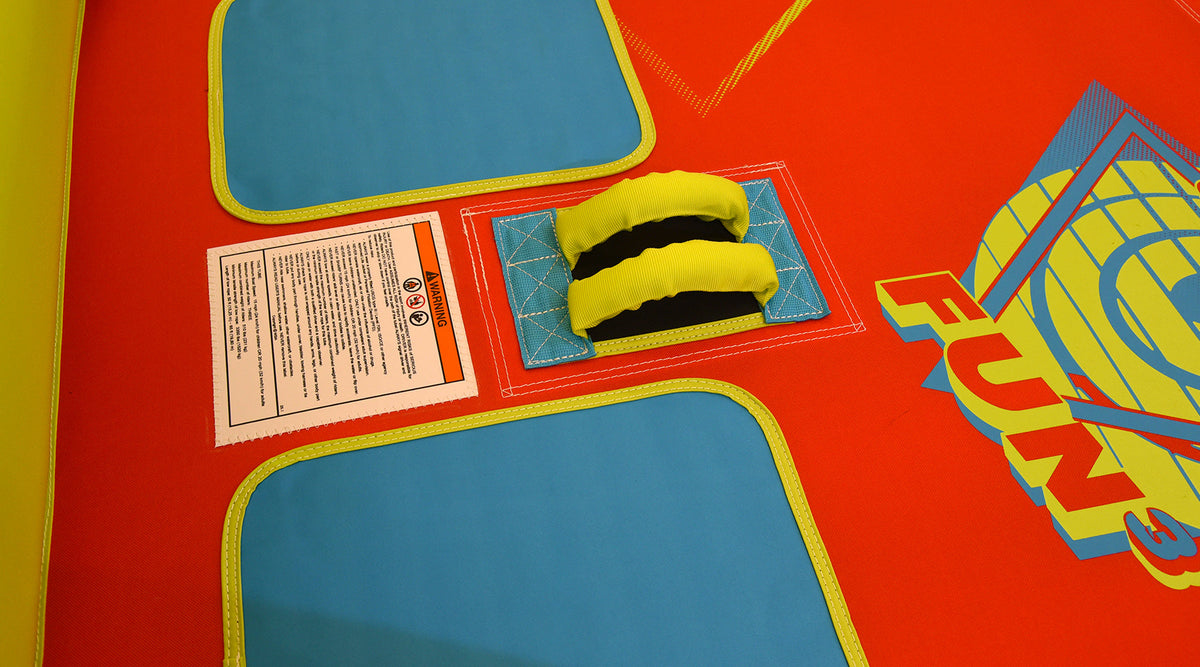 Detail of Fun 3 handle grips and blue seating pads on red surface.