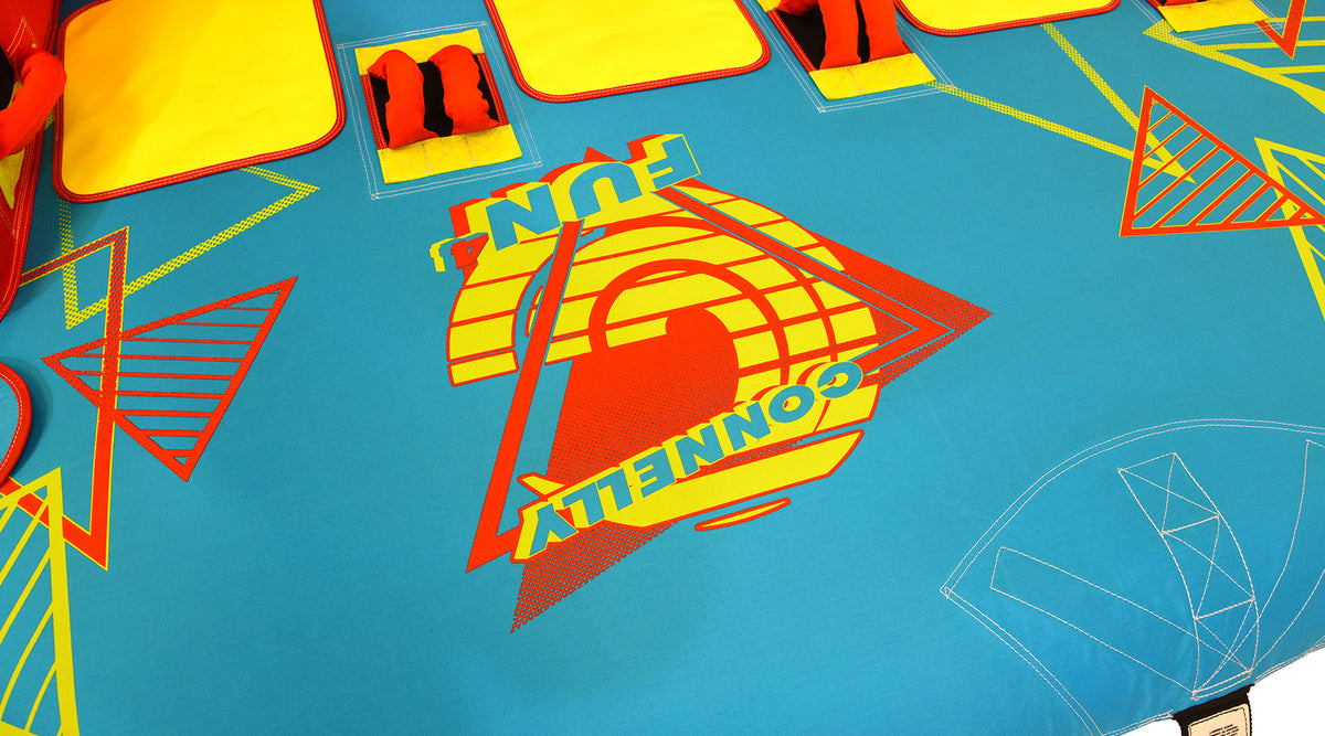Close-up of Fun 4 logo graphic on blue surface with geometric accents.
