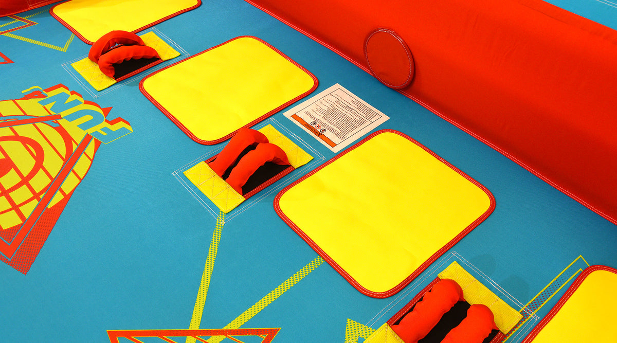 Close-up of Fun 4 seating area with yellow pads and red handle grips.