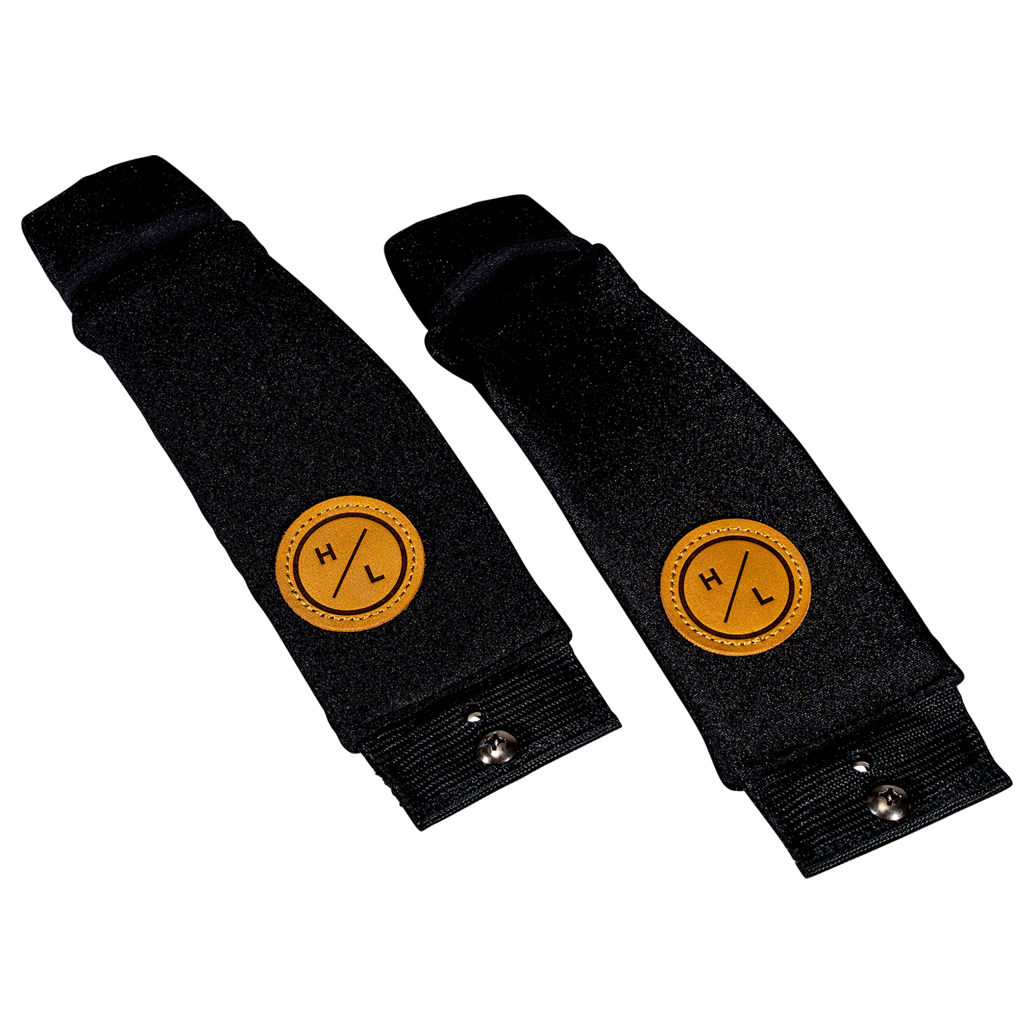 Angled view of two black neoprene foil board foot straps with tan HL logo patches.