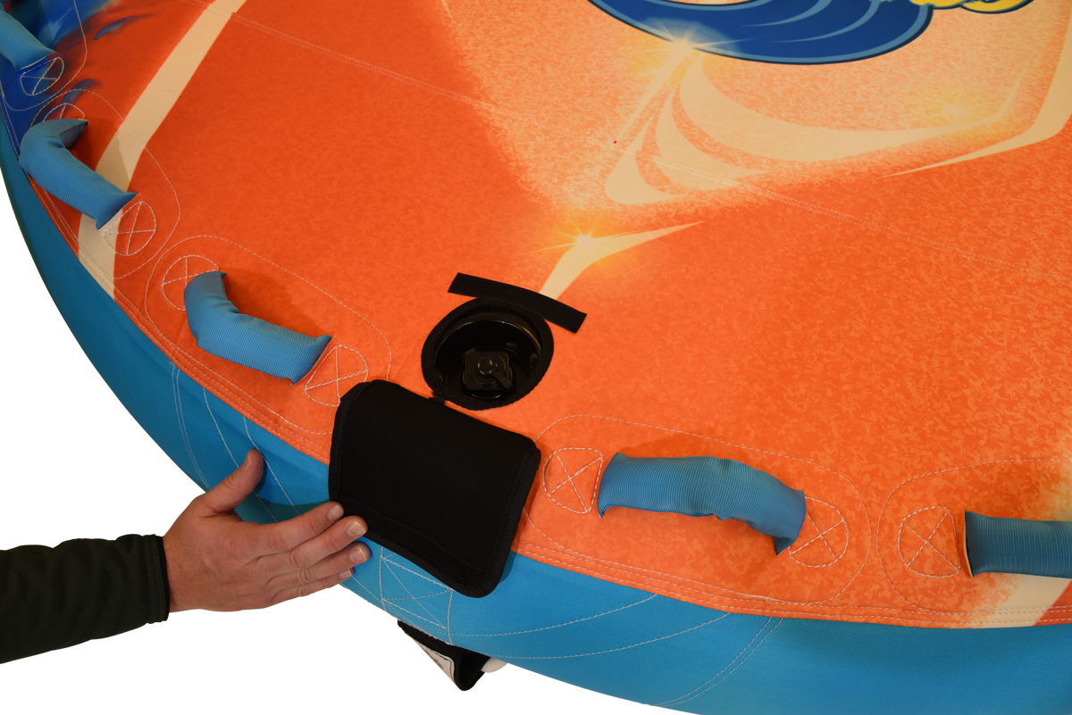 Close-up of hand opening valve cover on Convertible Soft Top with blue grab handles nearby.