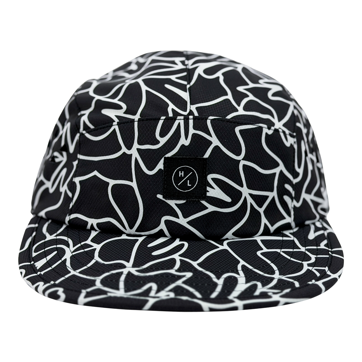 Lucas 5 Panel Hat front view with black and white abstract pattern and small logo patch.