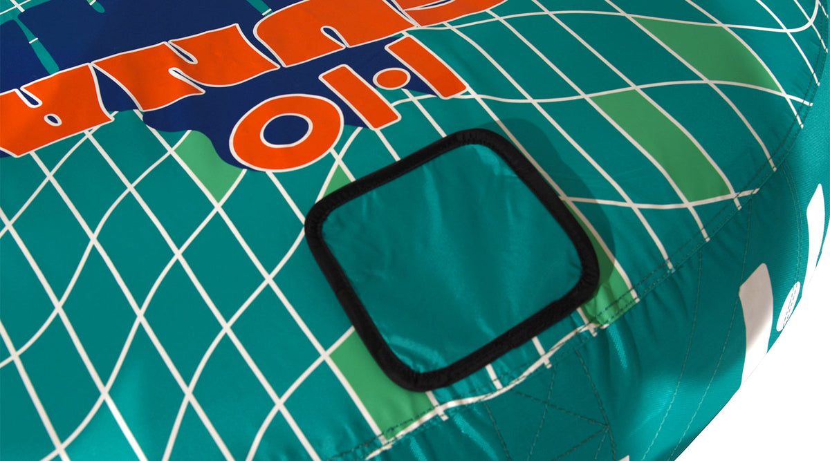 Close-up top view of Laguna 2 Tube with teal square patch on grid design.