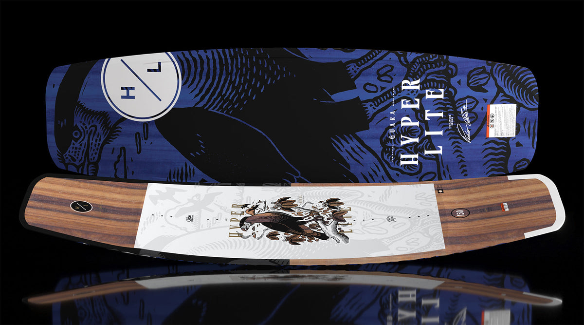 Angled top and base view of Guara 147cm wakeboard showing wood grain top and blue base artwork.