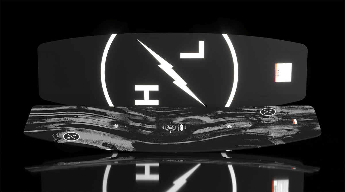Angled view of Impulse wakeboard showing marbled top and bold HL lightning logo on base.