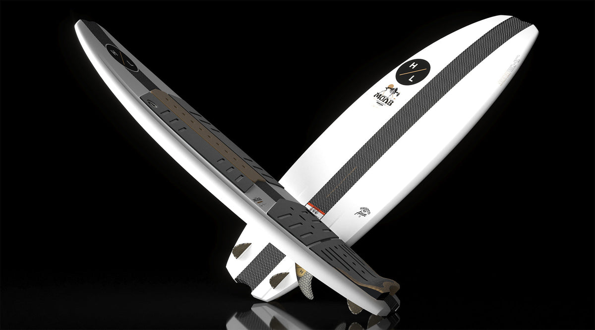 Angled view of MOAB board showing black traction pads and carbon fiber stripe design.
