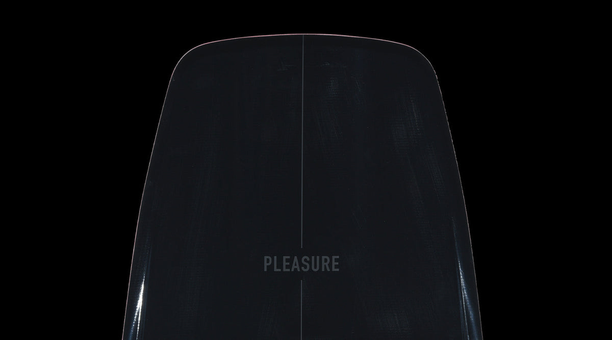 Close-up of the Pleasure wakeboard nose showing subtle centerline and glossy black finish.