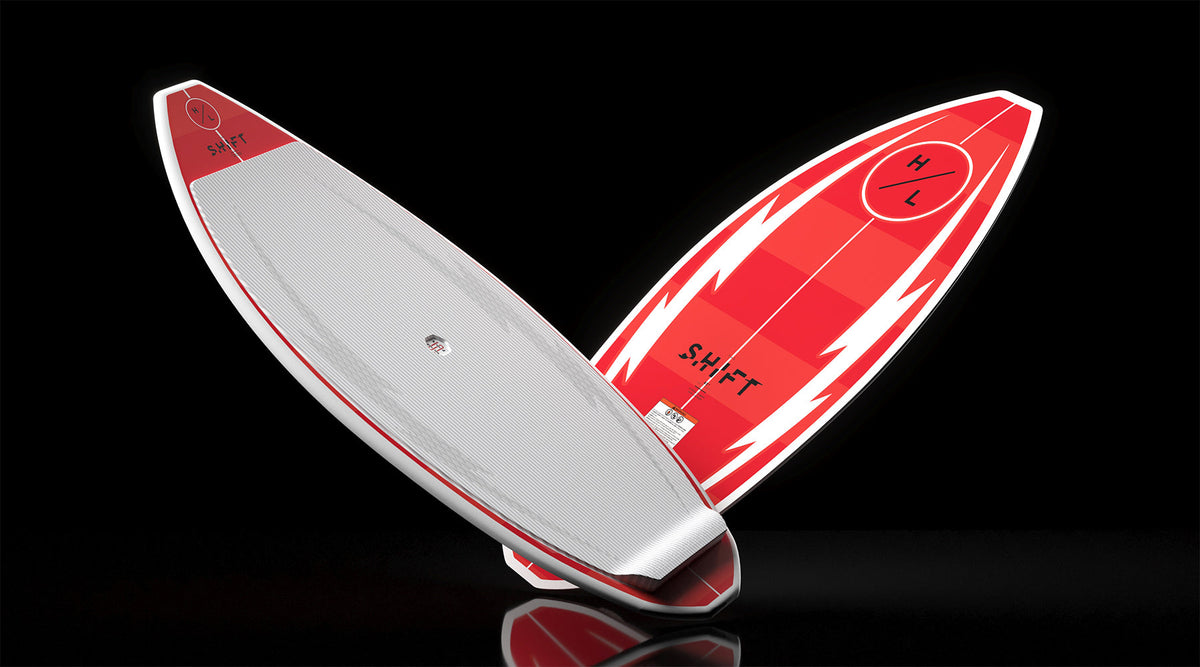 Angled view of Shift wakesurf boards showing white traction pad and red base.
