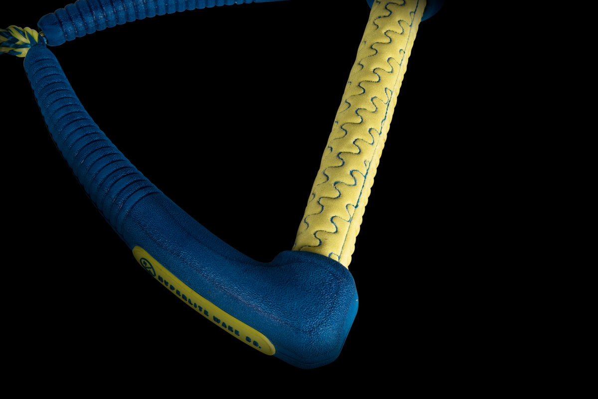 Zoomed view of Pro Surf Ropes blue & yellow handle with textured grip.
