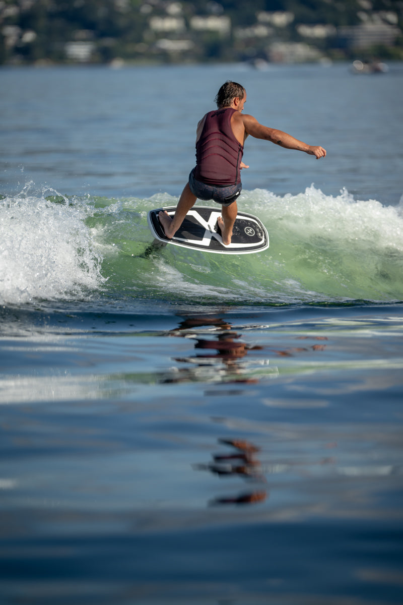 Person surfing on a lake wave with a Starship w/Falcon Foil Kit board.