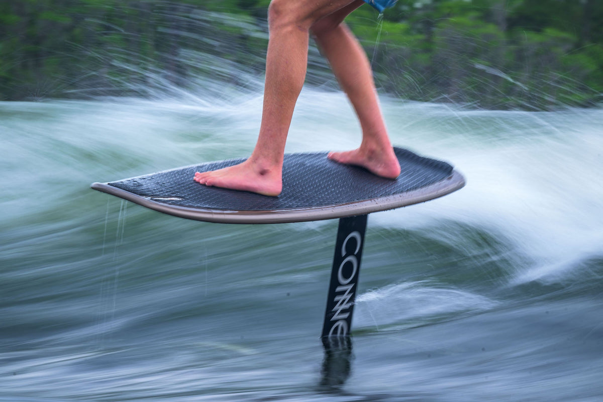 Person riding a Connelly wakefoil in the water.