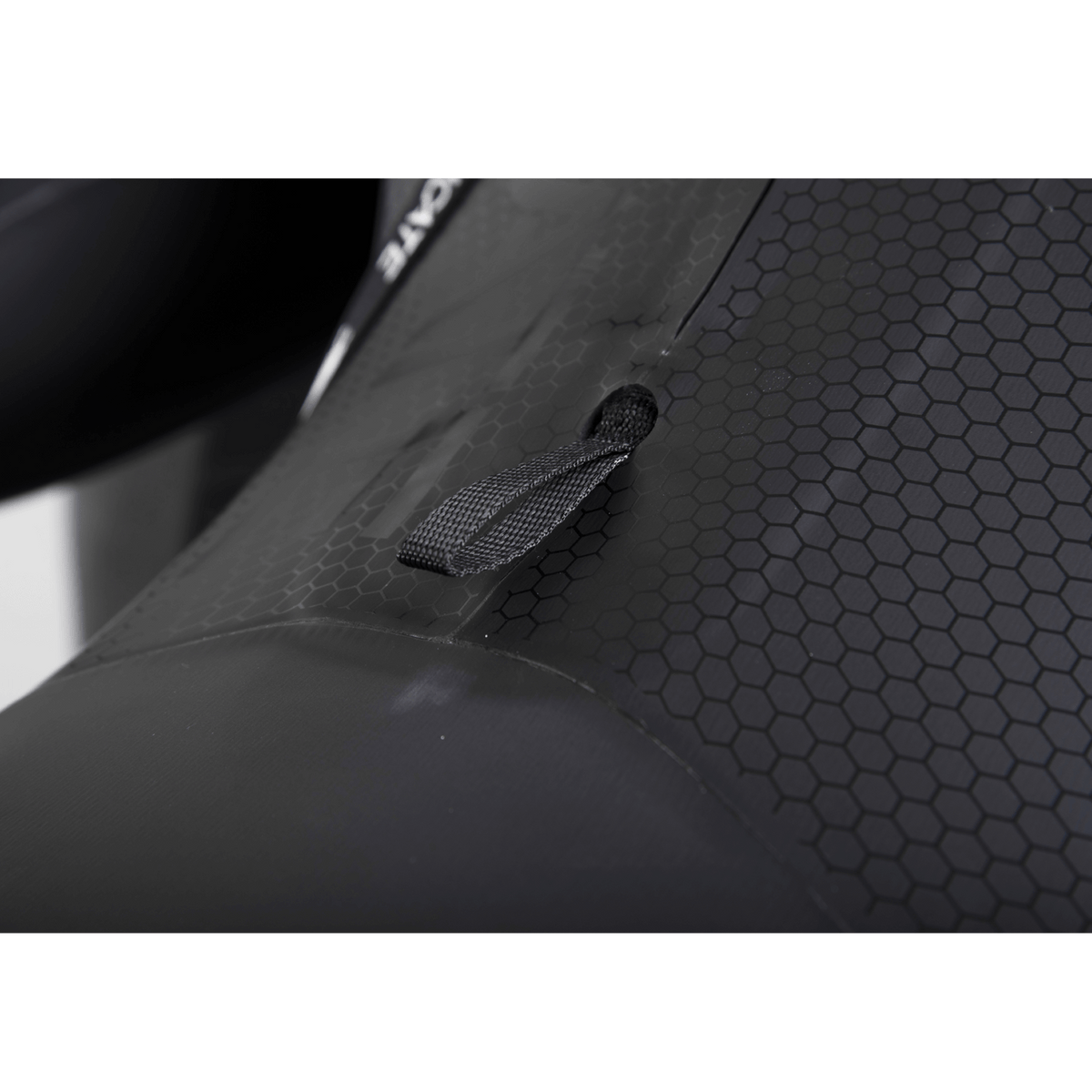 Close-up of the wetsuit‚Äôs hex-textured panel, featuring a reinforced pull tab for adjustments and added durability.
